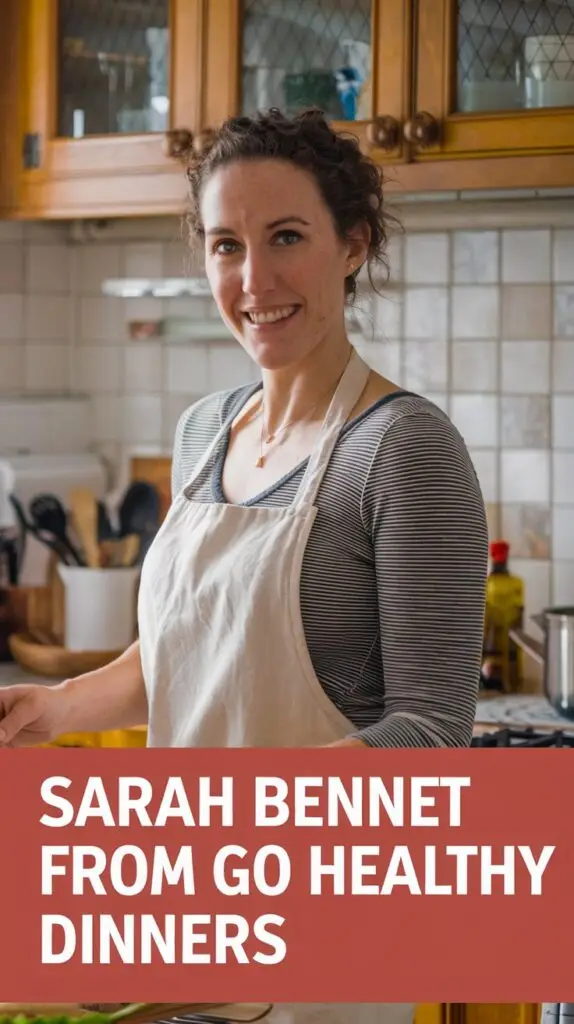 A photo of a woman named Sarah Bennett from Go Healthy Dinners in her home kitchen. She is cooking and wearing a casual outfit with an apron. The background is a cozy kitchen with wooden cabinets, a tile floor, and a few cooking utensils. The bold text overlay at the bottom of the image says "Sarah Bennett from Go Healthy Dinners".